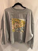 Full view of grey Kimchi Blue sweatshirt on hanger