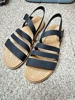 Full view of both sandals showing strap layout and colors