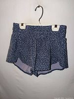 Front view of blue/purple patterned athletic shorts on hanger