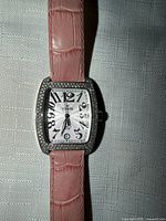 Front view showing dial, bezel, strap color and style