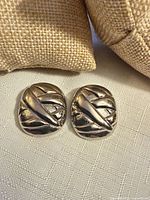 Front view of both earrings showing design and finish