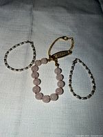 three of the bead bracelets laid out on fabric background