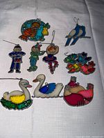 All nine stained glass ornaments displayed on cloth