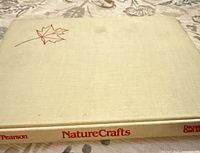 Front cover showing beige cloth and red maple leaf motif