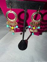 Both earrings front view on stand