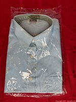 Front view of sealed package showing folded striped shirt