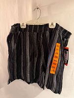 Front view of black and white striped Briggs shorts showing elastic waistband and tag