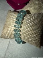 Bracelet displayed on cushion, showing color and bead faceting