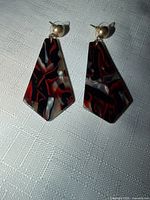 Both earrings front view showing swirl pattern and studs