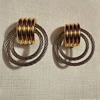 front view of earrings showing gold ridged tops and silver twisted hoops