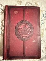 Front cover showing red cloth and embossed design