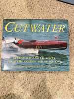 Front cover of hardcover book showing title and boat image