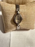 Front view of Elgin watch on fabric pillow