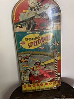 Full front view of 500 Mile Speedway Game showing graphic, marbles and two red feet