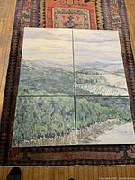 Full view of the four panels assembled on floor showing complete landscape artwork