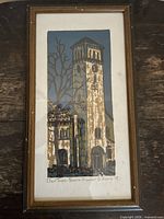 Front view of framed woodcut print showing artwork, mat and frame