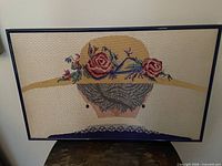 Front view of framed beaded needlework artwork