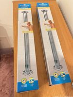Two boxed AquaSense 24" grab bars on tabletop