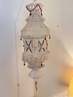 Full view of macramé hanging lamp unlit showing complete shape