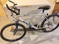 Full left-side view of CCM silver/blue mountain bike