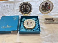 Entire lot showing boxed trinket box in Coalport box, two decorative plates on stands, boxed historical spoon