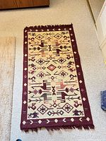 Full view of rug showing pattern, colors and fringe