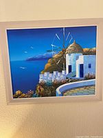 Front view of framed painting showing Mykonos scene