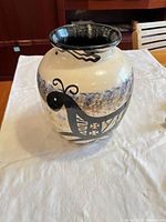 Front view of cream ceramic vase with multicolor Southwestern bird design