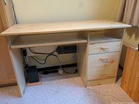 Front view of the desk showing top, pedestal drawers, and open knee space