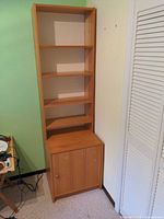 Front view of tall IKEA Billy bookcase showing shelves and lower cabinet