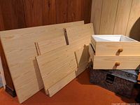 Particleboard panels and two drawers with pine knobs