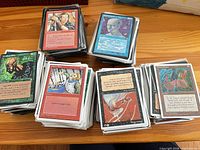 Overview of several stacks of Magic cards on table