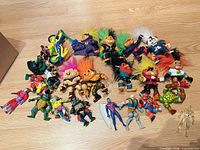 Full lot overview on floor showing all figures and motorcycle