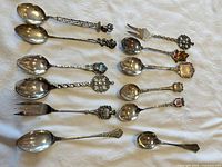 All twelve flatware pieces laid out on cloth