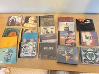 Full layout of all 18 CDs in jewel cases on tabletop