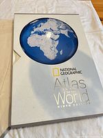 Front of slipcased atlas showing title and globe graphic