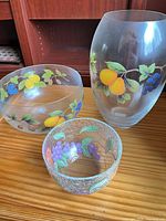 Group shot of clear vase, frosted bowl and crackle bowl on wood surface