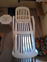 white plastic chaise lounge and side stool