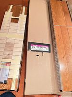 Three boxes of red oak engineered flooring planks