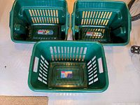 Top view showing all three green Rubbermaid laundry baskets