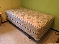 Twin mattress on box spring and metal frame