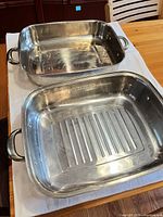 Both stainless steel roasting pans top view