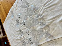 Six clear cut crystal sherry glasses on cloth