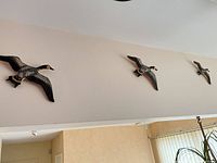 Three wood Canada geese wall plaques displayed on wall