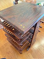 Full view of table showing top surface and slatted magazine shelves