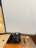 Projector on table with projection screen extended