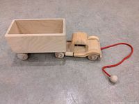 full view of wooden truck, trailer and red pull string