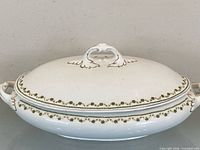 Top view of covered dish showing finial and floral trim