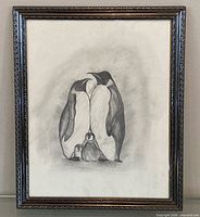 Full view of framed penguin charcoal drawing