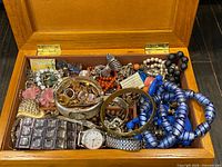 open jewelry box showing assorted jewelry